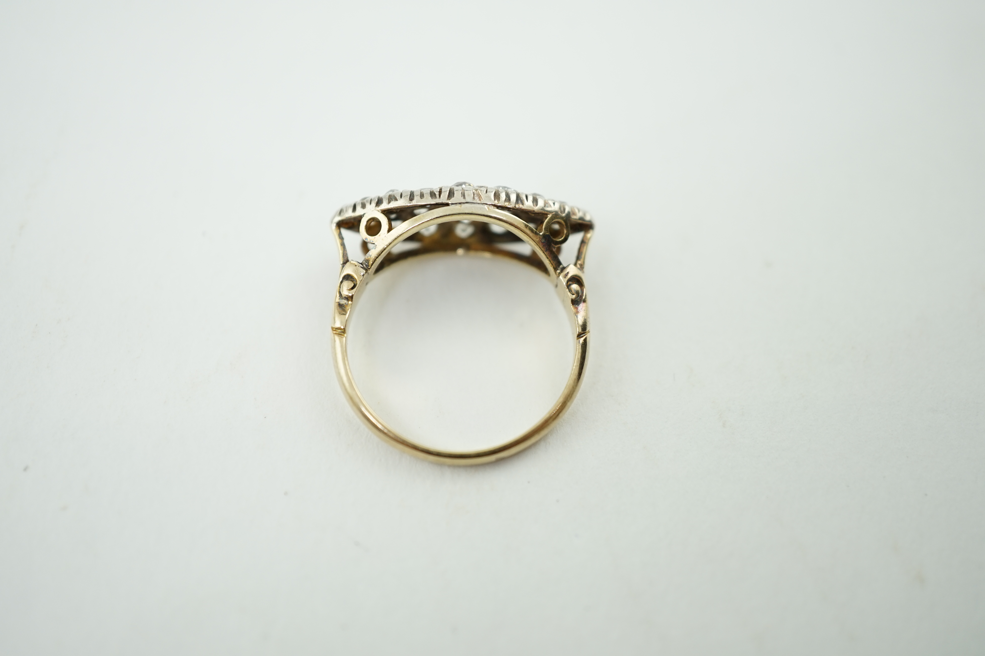 An early 20th century gold and diamond cluster set navette shaped ring